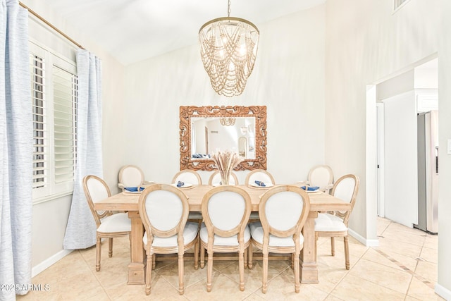 dining space featuring light tile patterned floors and a chandelier