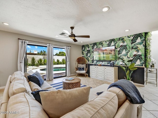 tiled living room with ceiling fan and a textured ceiling