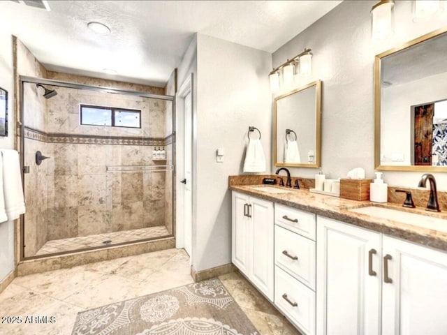 bathroom with vanity and a shower with door