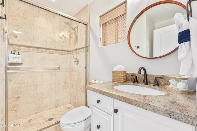 bathroom with walk in shower, vanity, and toilet