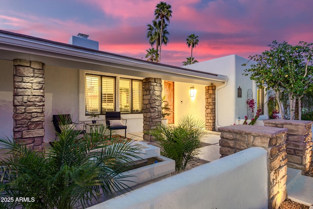 patio terrace at dusk with covered porch