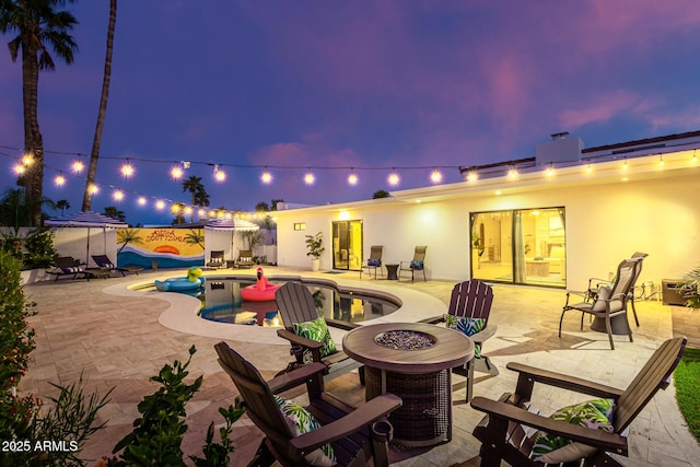 patio terrace at dusk with a fire pit