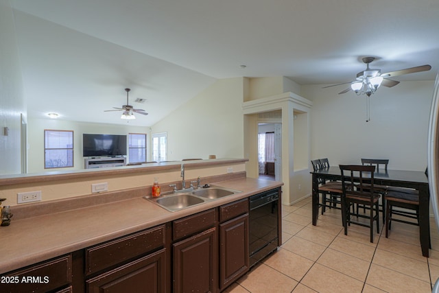 kitchen with vaulted ceiling, sink, black dishwasher, light tile patterned floors, and dark brown cabinets