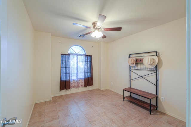 tiled empty room with ceiling fan