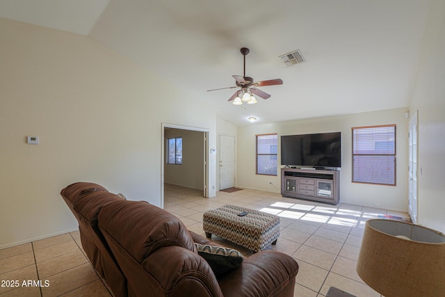 living room with ceiling fan, light tile patterned flooring, and lofted ceiling