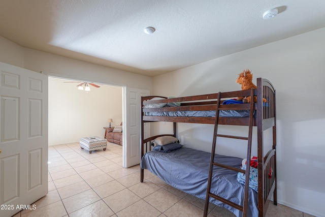 bedroom featuring a textured ceiling and light tile patterned floors