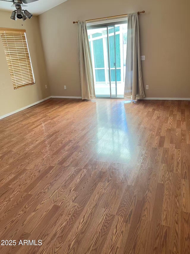 8507 W Pioneer St, Tolleson, AZ 85353 - empty room with wood finished floors and ceiling fan