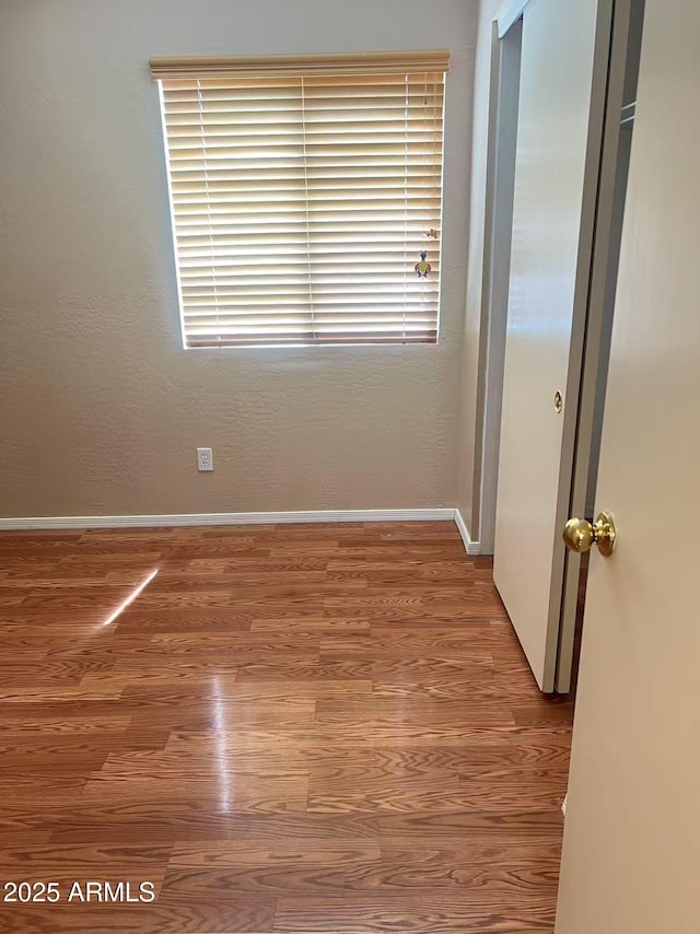 8507 W Pioneer St, Tolleson, AZ 85353 - unfurnished room featuring wood finished floors and baseboards