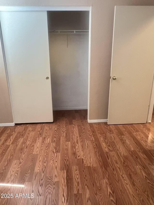 8507 W Pioneer St, Tolleson, AZ 85353 - unfurnished bedroom with wood finished floors and a closet