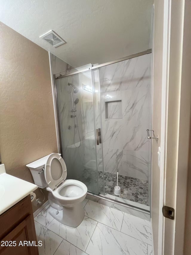 8507 W Pioneer St, Tolleson, AZ 85353 - full bath with a textured wall, vanity, a marble finish shower, and marble look tile flooring