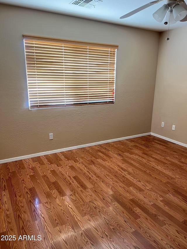 8507 W Pioneer St, Tolleson, AZ 85353 - empty room with ceiling fan and wood finished floors