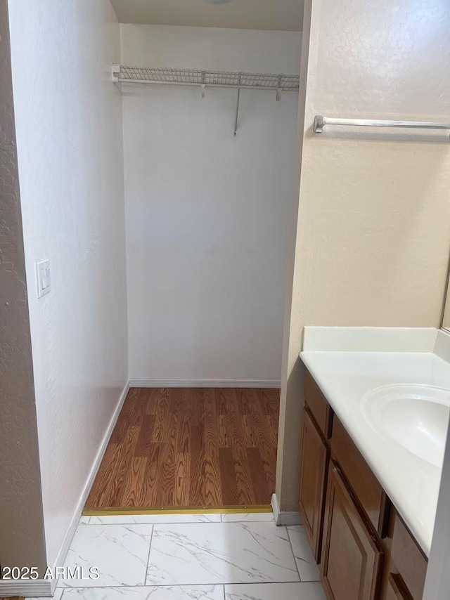 8507 W Pioneer St, Tolleson, AZ 85353 - bathroom featuring marble finish floors, vanity, and a spacious closet