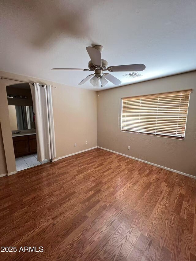 8507 W Pioneer St, Tolleson, AZ 85353 - spare room featuring light wood finished floors and a ceiling fan