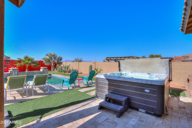 view of patio with a swimming pool with hot tub