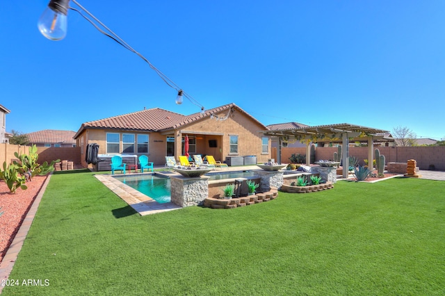 back of house featuring a yard, a pergola, and a pool with hot tub