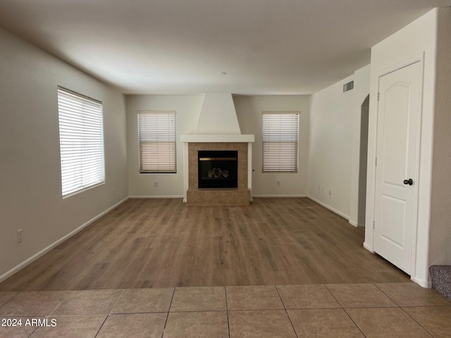 unfurnished living room featuring dark hardwood / wood-style floors and a fireplace