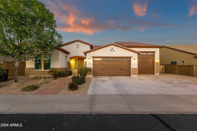 mediterranean / spanish-style house with a garage