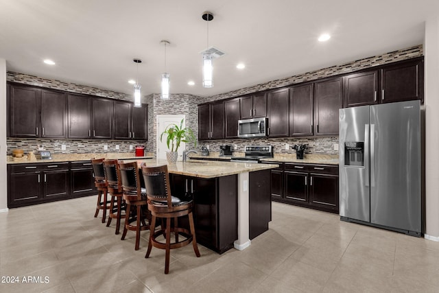 kitchen featuring backsplash, hanging light fixtures, stainless steel appliances, and dark brown cabinetry