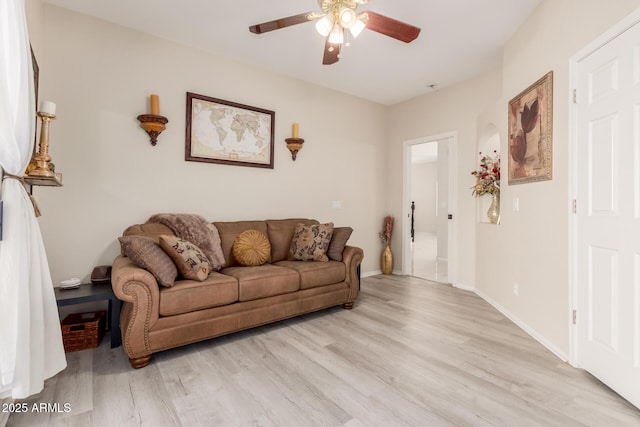 living room with ceiling fan, light wood-type flooring, and baseboards