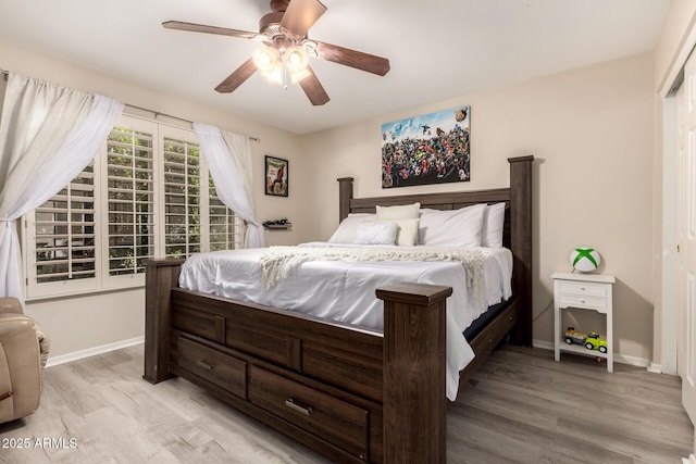 bedroom featuring light wood-type flooring, ceiling fan, and baseboards