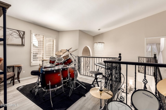 rec room with a healthy amount of sunlight, light wood-style floors, and baseboards