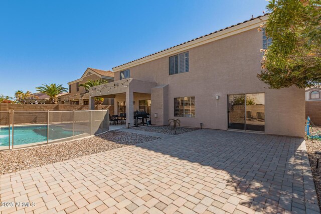 exterior space featuring a fenced in pool, a patio area, and fence