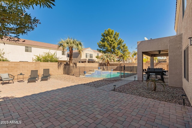 view of patio / terrace with a fenced backyard, a ceiling fan, and a fenced in pool