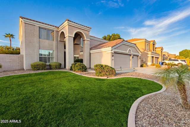 mediterranean / spanish house with a tile roof, a front lawn, and stucco siding