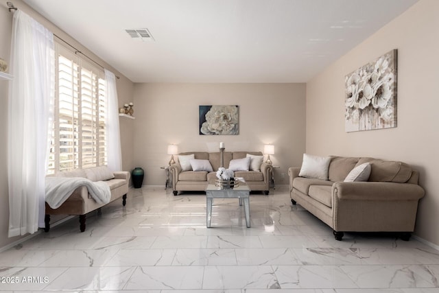 living area with marble finish floor, visible vents, and baseboards