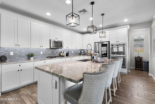 974 W Zion Way, Chandler, AZ 85248 - kitchen with a sink, stainless steel appliances, decorative backsplash, light wood-type flooring, and recessed lighting