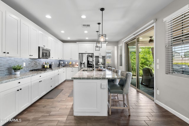 974 W Zion Way, Chandler, AZ 85248 - kitchen with stainless steel appliances, plenty of natural light, white cabinets, tasteful backsplash, and recessed lighting