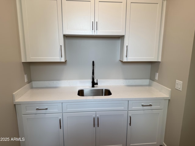 kitchen featuring sink and white cabinets