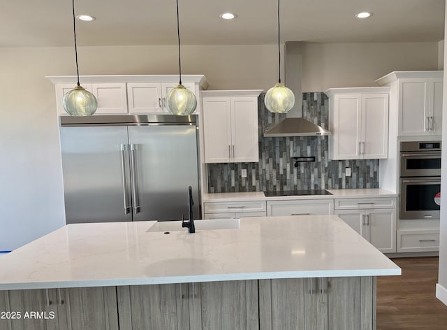 kitchen featuring white cabinetry, hanging light fixtures, light stone countertops, and appliances with stainless steel finishes