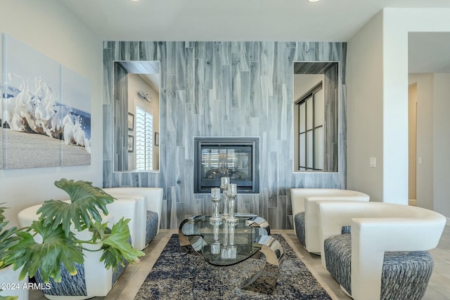 sitting room with light tile patterned floors and tile walls