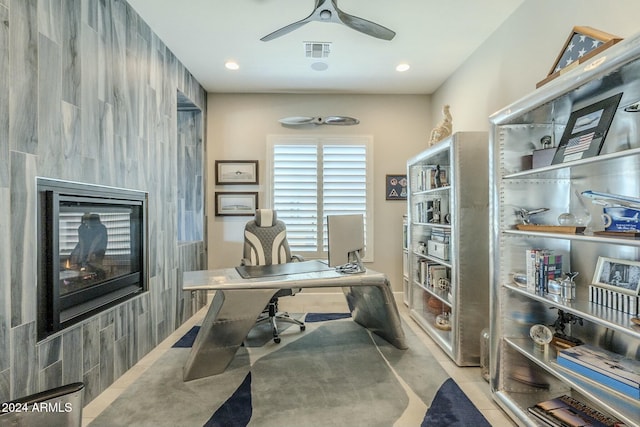 tiled office space with ceiling fan and tile walls