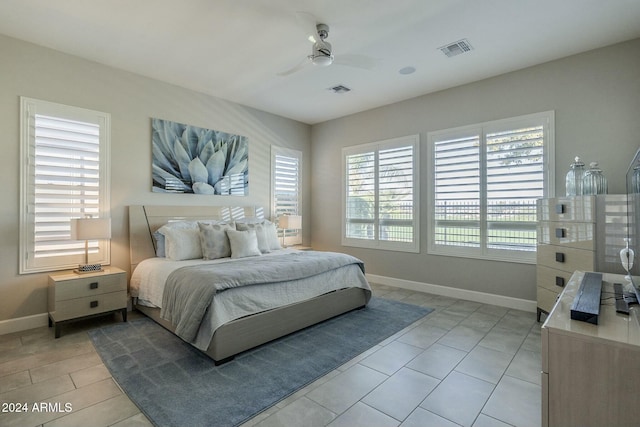 tiled bedroom with ceiling fan