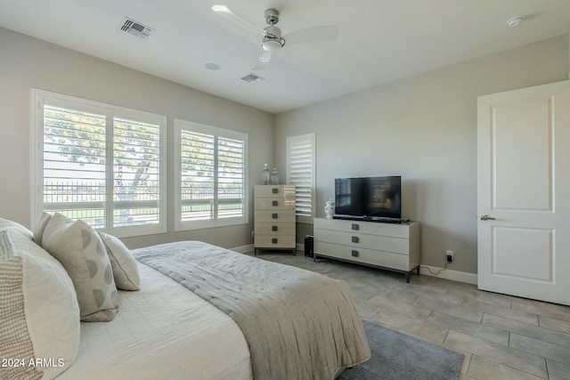 tiled bedroom with ceiling fan