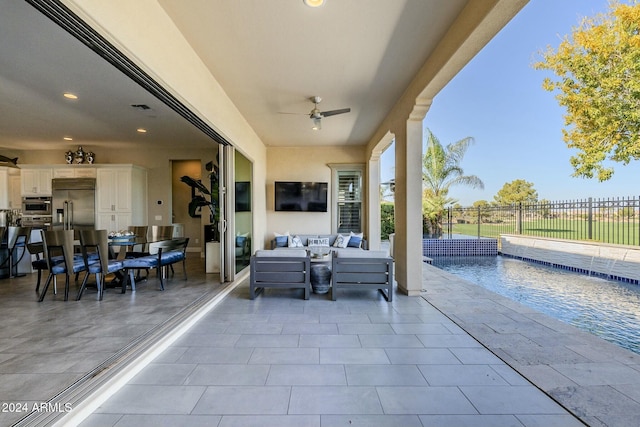 view of patio with a fenced in pool, ceiling fan, and an outdoor hangout area