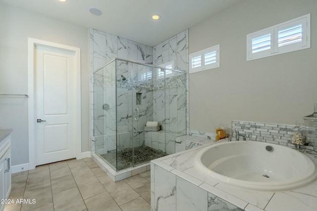 bathroom with separate shower and tub, tile patterned flooring, and vanity