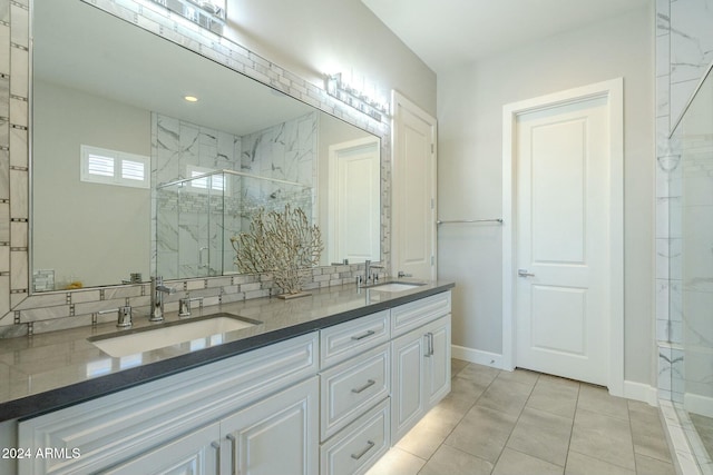 bathroom with tile patterned floors, vanity, and a shower with shower door