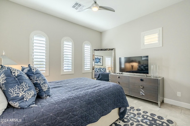 tiled bedroom with ceiling fan