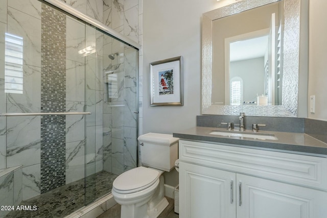 bathroom featuring vanity, toilet, and walk in shower