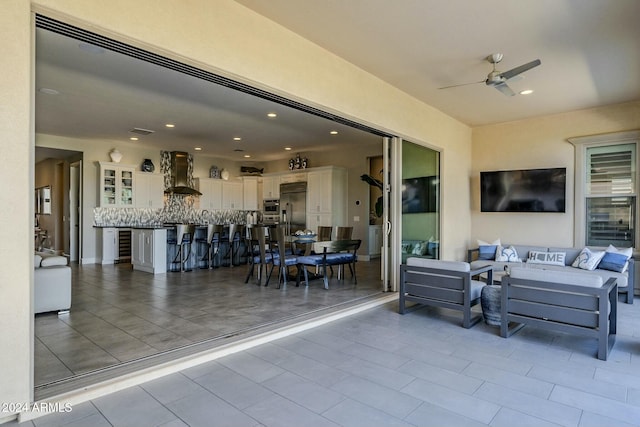 view of patio / terrace with an outdoor living space and ceiling fan