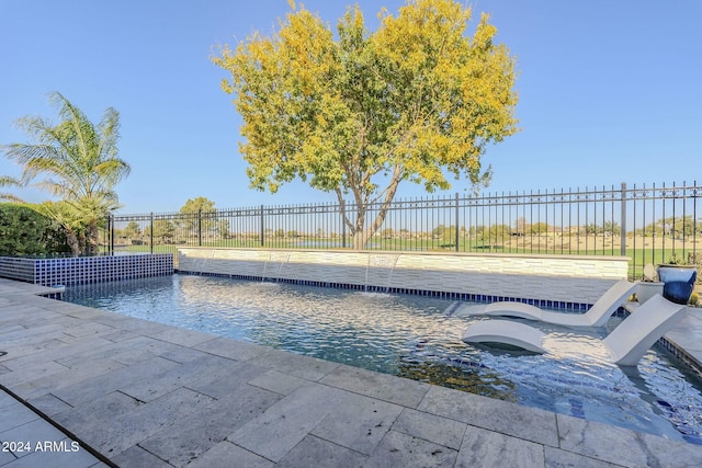 view of swimming pool with pool water feature