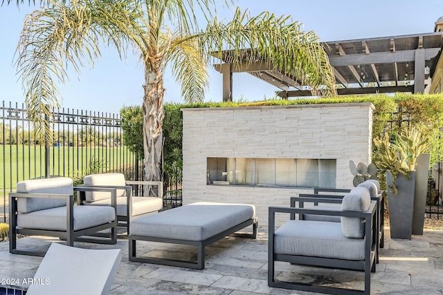 view of patio featuring a pergola and an outdoor stone fireplace