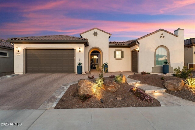 mediterranean / spanish home featuring a garage