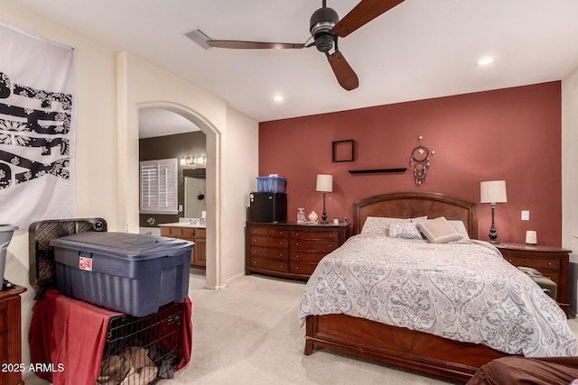 carpeted bedroom with ceiling fan and ensuite bathroom