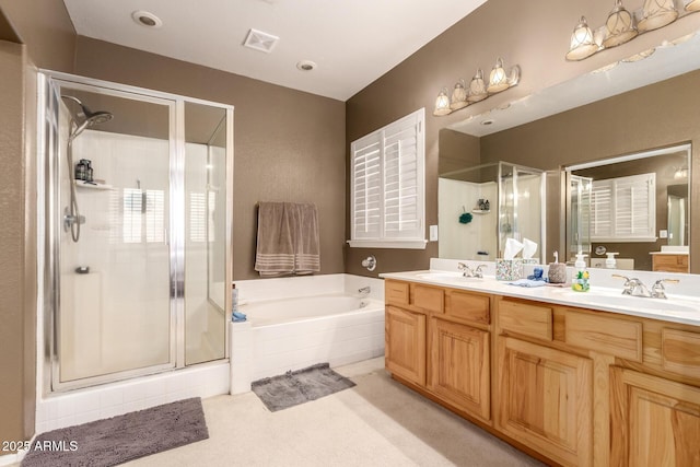 bathroom featuring vanity and shower with separate bathtub