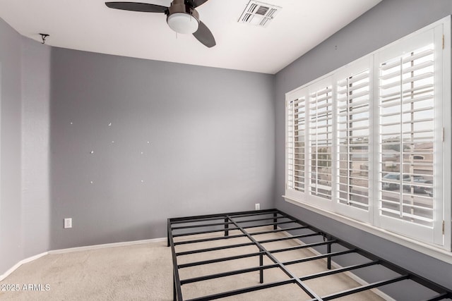 unfurnished bedroom featuring ceiling fan and carpet