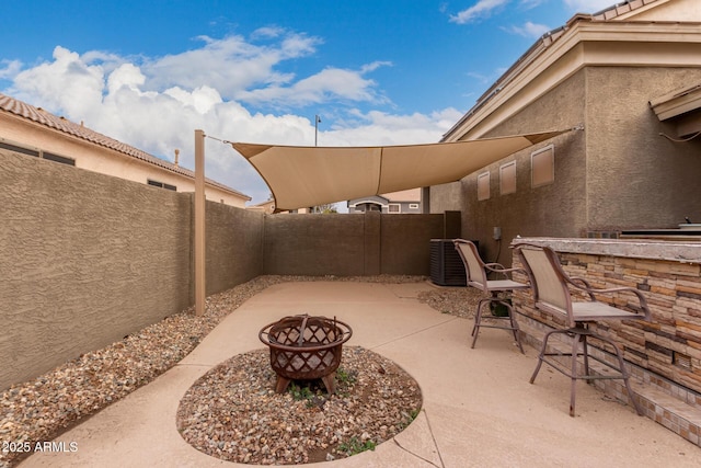 view of patio / terrace featuring an outdoor bar and a fire pit